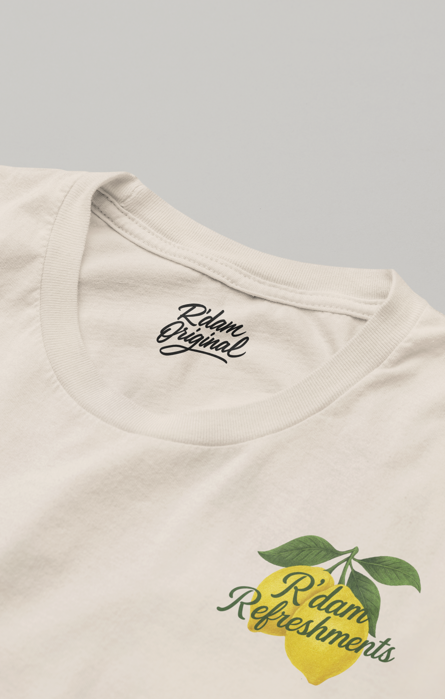 Crèmekleurig shirt met lemon print, coastal vibes & R’dam Original tekst – voorkant